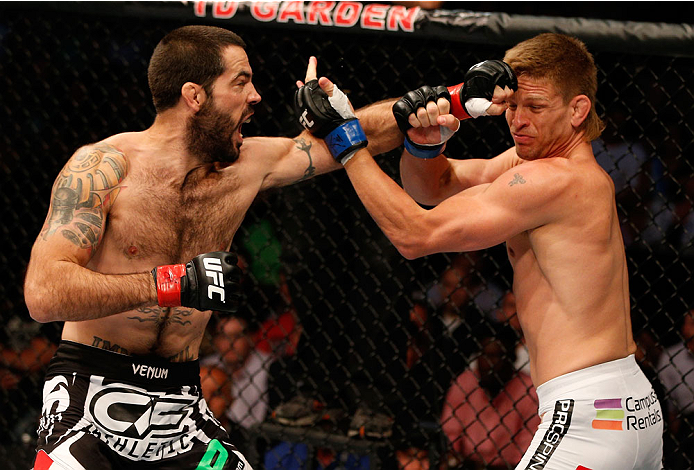 BOSTON, MA - AUGUST 17:  (L-R) Matt Brown punches Mike Pyle in their UFC welterweight bout at TD Garden on August 17, 2013 in Boston, Massachusetts. (Photo by Josh Hedges/Zuffa LLC/Zuffa LLC via Getty Images)