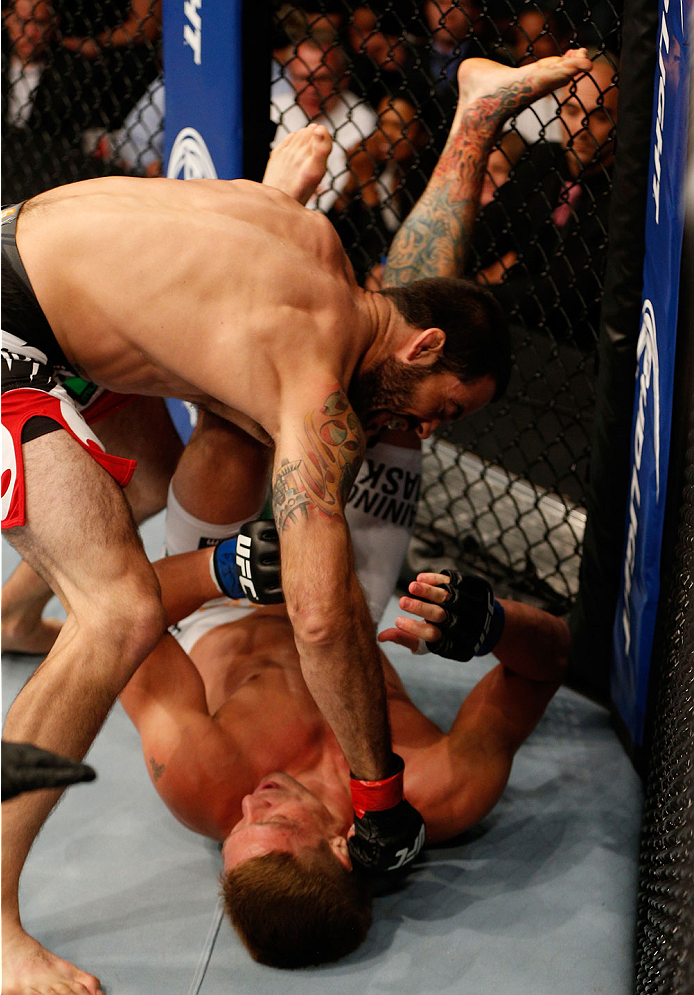 BOSTON, MA - AUGUST 17: (L-R) Matt Brown punches Mike Pyle in their UFC welterweight bout at TD Garden on August 17, 2013 in Boston, Massachusetts. (Photo by Josh Hedges/Zuffa LLC/Zuffa LLC via Getty Images)