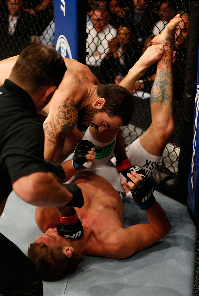 BOSTON, MA - AUGUST 17: (L-R) Matt Brown punches Mike Pyle in their UFC welterweight bout at TD Garden on August 17, 2013 in Boston, Massachusetts. (Photo by Josh Hedges/Zuffa LLC/Zuffa LLC via Getty Images)