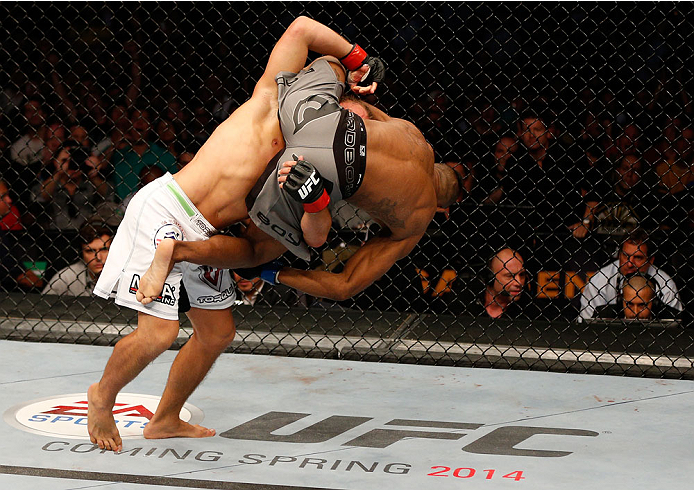 BOSTON, MA - AUGUST 17:  (L-R) Urijah Faber takes down Iuri Alcantara in their UFC bantamweight bout at TD Garden on August 17, 2013 in Boston, Massachusetts. (Photo by Josh Hedges/Zuffa LLC/Zuffa LLC via Getty Images)