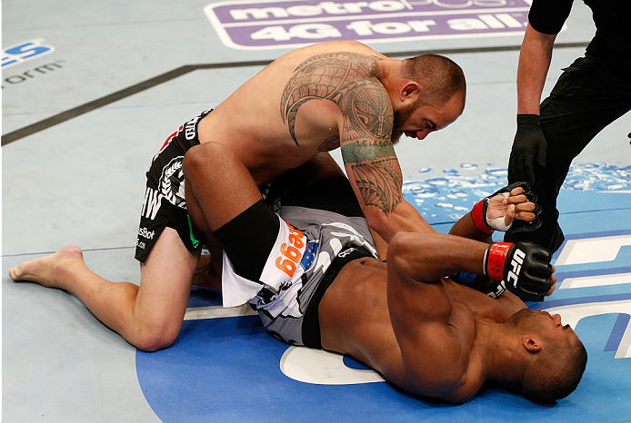 BOSTON, MA - AUGUST 17:  (L-R) Travis Browne knocks out Alistair Overeem with a series of punches in their UFC heavyweight bout at TD Garden on August 17, 2013 in Boston, Massachusetts. (Photo by Josh Hedges/Zuffa LLC/Zuffa LLC via Getty Images)