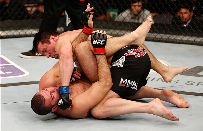 BOSTON, MA - AUGUST 17: Chael Sonnen (top) punches Mauricio "Shogun" Rua in their UFC light heavyweight bout at TD Garden on August 17, 2013 in Boston, Massachusetts. (Photo by Josh Hedges/Zuffa LLC/Zuffa LLC via Getty Images)