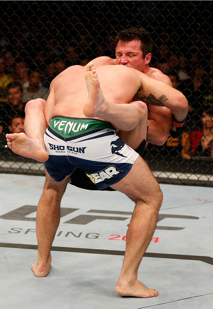 BOSTON, MA - AUGUST 17: (R-L) Chael Sonnen secures a guillotine choke submission against Mauricio "Shogun" Rua in their UFC light heavyweight bout at TD Garden on August 17, 2013 in Boston, Massachusetts. (Photo by Josh Hedges/Zuffa LLC/Zuffa LLC via Get