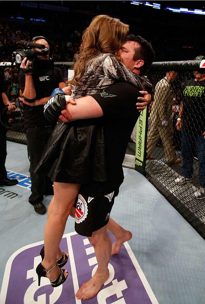 BOSTON, MA - AUGUST 17:  (R-L) Chael Sonnen celebrates with his wife Brittany after his submission victory over Mauricio "Shogun" Rua in their UFC light heavyweight bout at TD Garden on August 17, 2013 in Boston, Massachusetts. (Photo by Josh Hedges/Zuffa