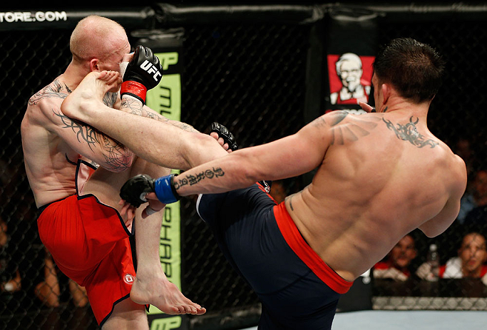 GOLD COAST, AUSTRALIA - DECEMBER 15:  (R-L) Norman Parke kicks Colin Fletcher during their lightweight fight at the UFC on FX event on December 15, 2012  at Gold Coast Convention and Exhibition Centre in Gold Coast, Australia.  (Photo by Josh Hedges/Zuffa