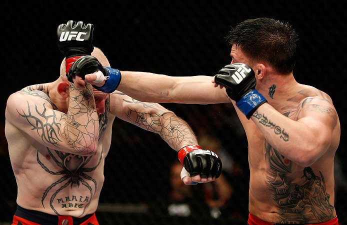 GOLD COAST, AUSTRALIA - DECEMBER 15:  (R-L) Norman Parke punches Colin Fletcher during their lightweight fight at the UFC on FX event on December 15, 2012  at Gold Coast Convention and Exhibition Centre in Gold Coast, Australia.  (Photo by Josh Hedges/Zuf