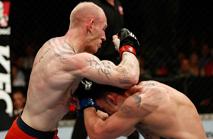 GOLD COAST, AUSTRALIA - DECEMBER 15:  (L-R) Colin Fletcher delivers an elbow strike against Norman Parke during their lightweight fight at the UFC on FX event on December 15, 2012  at Gold Coast Convention and Exhibition Centre in Gold Coast, Australia.  