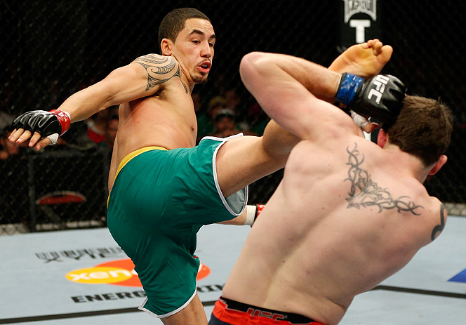 GOLD COAST, AUSTRALIA - DECEMBER 15:  (L-R) Robert Whittaker kicks Bradley Scott during their welterweight fight at the UFC on FX event on December 15, 2012  at Gold Coast Convention and Exhibition Centre in Gold Coast, Australia.  (Photo by Josh Hedges/Z