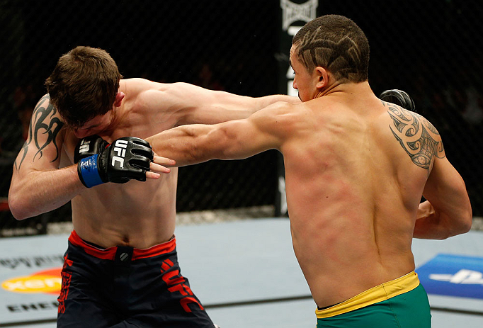 GOLD COAST, AUSTRALIA - DECEMBER 15:  (R-L) Robert Whittaker punches Bradley Scott during their welterweight fight at the UFC on FX event on December 15, 2012  at Gold Coast Convention and Exhibition Centre in Gold Coast, Australia.  (Photo by Josh Hedges