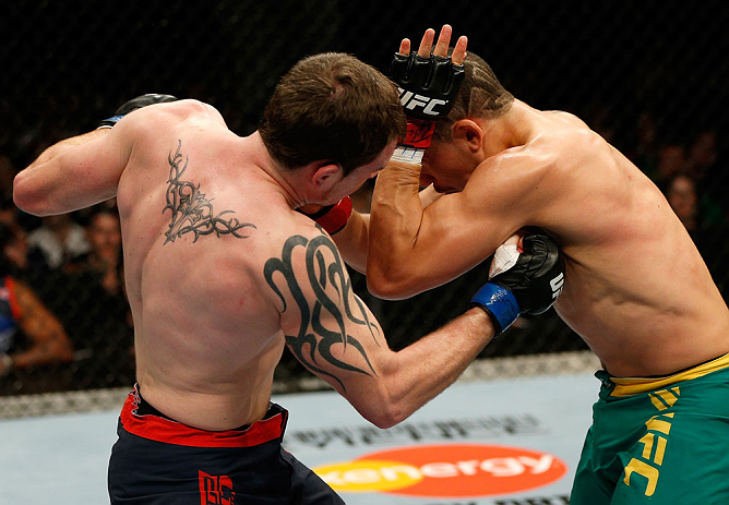 GOLD COAST, AUSTRALIA - DECEMBER 15:  (L-R) Bradley Scott punches Robert Whittaker during their welterweight fight at the UFC on FX event on December 15, 2012  at Gold Coast Convention and Exhibition Centre in Gold Coast, Australia.  (Photo by Josh Hedges