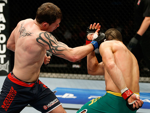 GOLD COAST, AUSTRALIA - DECEMBER 15:  (L-R) Bradley Scott punches Robert Whittaker during their welterweight fight at the UFC on FX event on December 15, 2012  at Gold Coast Convention and Exhibition Centre in Gold Coast, Australia.  (Photo by Josh Hedges