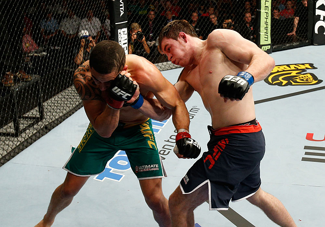 GOLD COAST, AUSTRALIA - DECEMBER 15:  (R-L) Bradley Scott punches Robert Whittaker during their welterweight fight at the UFC on FX event on December 15, 2012  at Gold Coast Convention and Exhibition Centre in Gold Coast, Australia.  (Photo by Josh Hedges