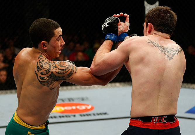 GOLD COAST, AUSTRALIA - DECEMBER 15:  (L-R) Robert Whittaker punches Bradley Scott during their welterweight fight at the UFC on FX event on December 15, 2012  at Gold Coast Convention and Exhibition Centre in Gold Coast, Australia.  (Photo by Josh Hedges