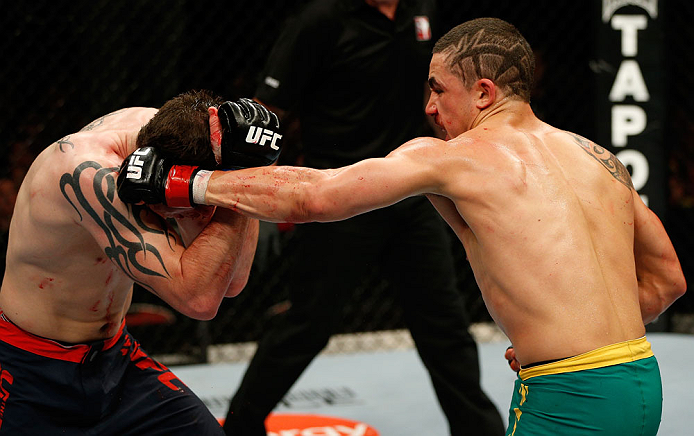 GOLD COAST, AUSTRALIA - DECEMBER 15:  (R-L) Robert Whittaker punches Bradley Scott during their welterweight fight at the UFC on FX event on December 15, 2012  at Gold Coast Convention and Exhibition Centre in Gold Coast, Australia.  (Photo by Josh Hedges