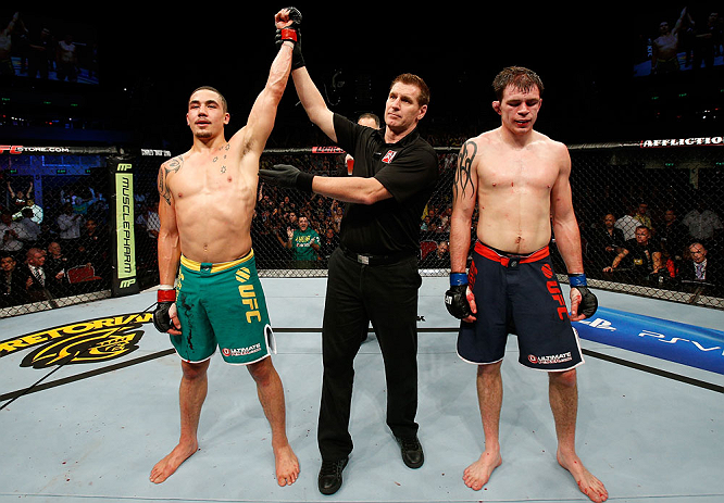 GOLD COAST, AUSTRALIA - DECEMBER 15:  Robert Whittaker (L) reacts after defeating Bradley Scott during their welterweight fight at the UFC on FX event on December 15, 2012  at Gold Coast Convention and Exhibition Centre in Gold Coast, Australia.  (Photo b