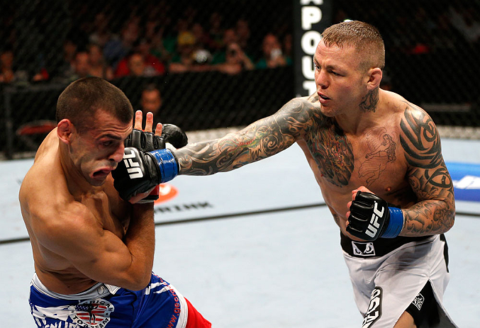 GOLD COAST, AUSTRALIA - DECEMBER 15:  (R-L) Ross Pearson punches George Sotiropoulos during their lightweight fight at the UFC on FX event on December 15, 2012  at Gold Coast Convention and Exhibition Centre in Gold Coast, Australia.  (Photo by Josh Hedge