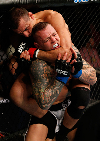GOLD COAST, AUSTRALIA - DECEMBER 15:  (L-R) George Sotiropoulos attempts a rear choke against Ross Pearson during their lightweight fight at the UFC on FX event on December 15, 2012  at Gold Coast Convention and Exhibition Centre in Gold Coast, Australia.