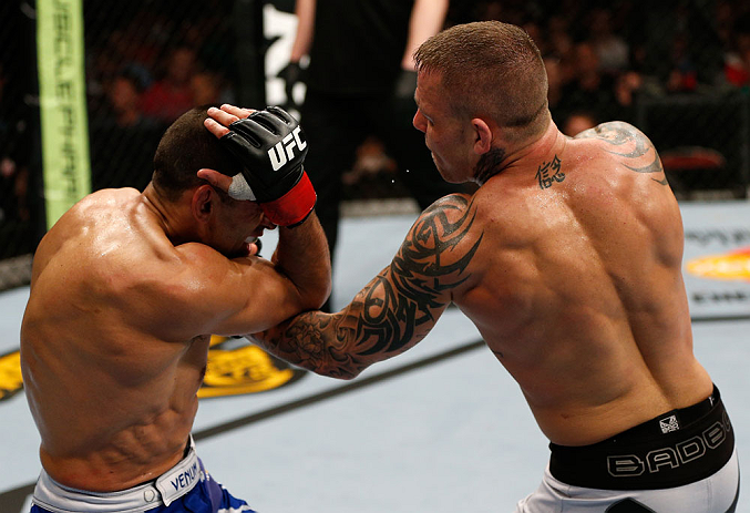 GOLD COAST, AUSTRALIA - DECEMBER 15:  (R-L) Ross Pearson punches George Sotiropoulos during their lightweight fight at the UFC on FX event on December 15, 2012  at Gold Coast Convention and Exhibition Centre in Gold Coast, Australia.  (Photo by Josh Hedge