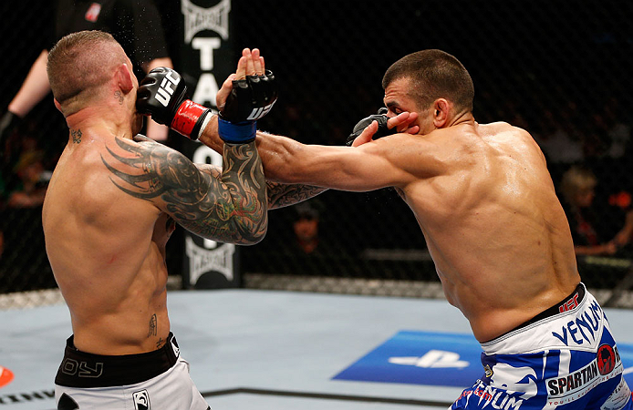 GOLD COAST, AUSTRALIA - DECEMBER 15:  (R-L) George Sotiropoulos punches Ross Pearson during their lightweight fight at the UFC on FX event on December 15, 2012  at Gold Coast Convention and Exhibition Centre in Gold Coast, Australia.  (Photo by Josh Hedge