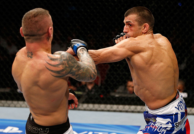 GOLD COAST, AUSTRALIA - DECEMBER 15:  (R-L) George Sotiropoulos punches Ross Pearson during their lightweight fight at the UFC on FX event on December 15, 2012  at Gold Coast Convention and Exhibition Centre in Gold Coast, Australia.  (Photo by Josh Hedge