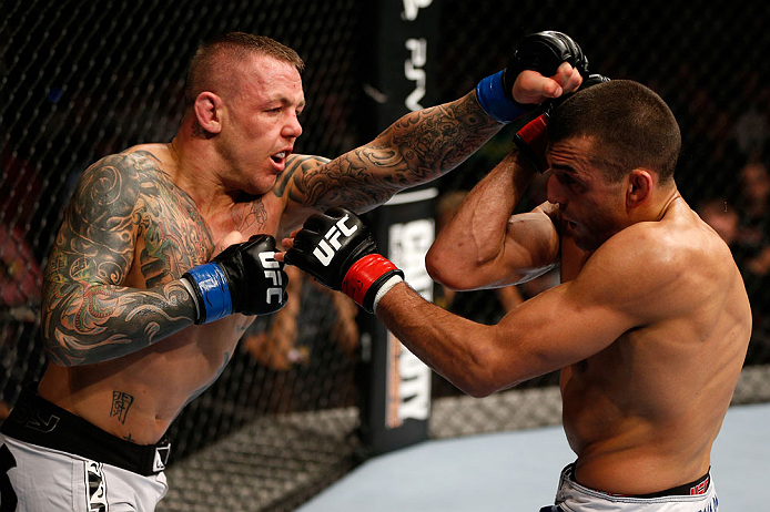 GOLD COAST, AUSTRALIA - DECEMBER 15:  (L-R) Ross Pearson punches George Sotiropoulos during their lightweight fight at the UFC on FX event on December 15, 2012  at Gold Coast Convention and Exhibition Centre in Gold Coast, Australia.  (Photo by Josh Hedge