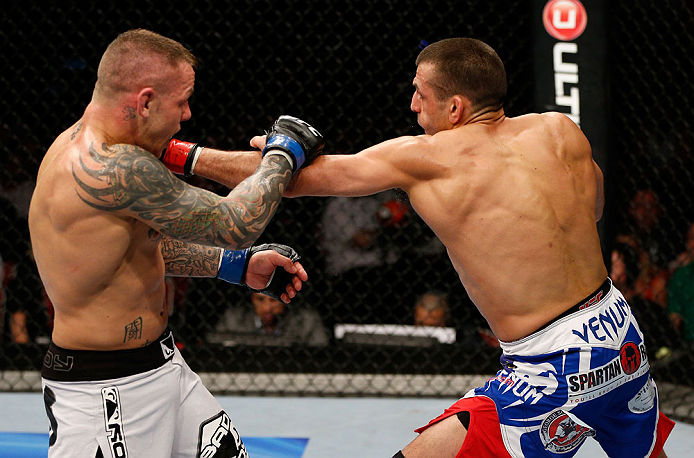 GOLD COAST, AUSTRALIA - DECEMBER 15:  (R-L) George Sotiropoulos punches Ross Pearson during their lightweight fight at the UFC on FX event on December 15, 2012  at Gold Coast Convention and Exhibition Centre in Gold Coast, Australia.  (Photo by Josh Hedge