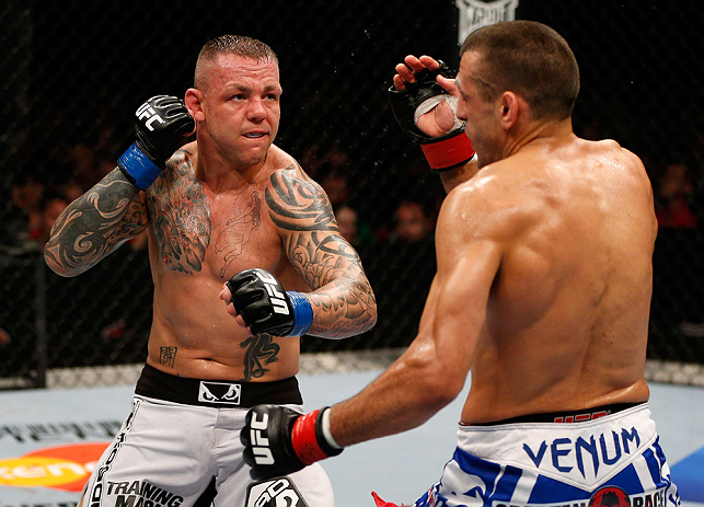 GOLD COAST, AUSTRALIA - DECEMBER 15:  (L-R) Ross Pearson punches George Sotiropoulos during their lightweight fight at the UFC on FX event on December 15, 2012  at Gold Coast Convention and Exhibition Centre in Gold Coast, Australia.  (Photo by Josh Hedge
