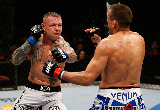 GOLD COAST, AUSTRALIA - DECEMBER 15:  (L-R) Ross Pearson punches George Sotiropoulos during their lightweight fight at the UFC on FX event on December 15, 2012  at Gold Coast Convention and Exhibition Centre in Gold Coast, Australia.  (Photo by Josh Hedge