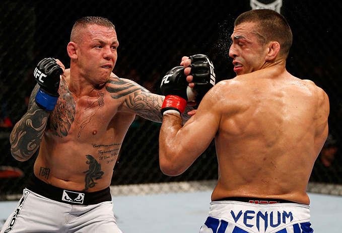GOLD COAST, AUSTRALIA - DECEMBER 15:  (L-R) Ross Pearson punches George Sotiropoulos during their lightweight fight at the UFC on FX event on December 15, 2012  at Gold Coast Convention and Exhibition Centre in Gold Coast, Australia.  (Photo by Josh Hedge