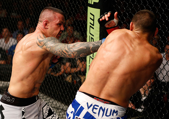 GOLD COAST, AUSTRALIA - DECEMBER 15:  (L-R) Ross Pearson punches George Sotiropoulos during their lightweight fight at the UFC on FX event on December 15, 2012  at Gold Coast Convention and Exhibition Centre in Gold Coast, Australia.  (Photo by Josh Hedge