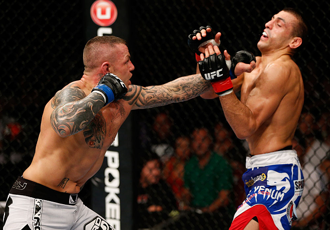 GOLD COAST, AUSTRALIA - DECEMBER 15:  (L-R) Ross Pearson punches George Sotiropoulos during their lightweight fight at the UFC on FX event on December 15, 2012  at Gold Coast Convention and Exhibition Centre in Gold Coast, Australia.  (Photo by Josh Hedge