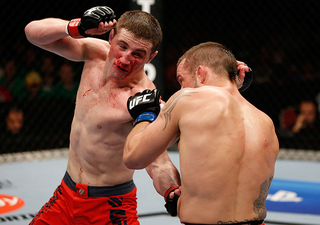 GOLD COAST, AUSTRALIA - DECEMBER 15:  (L-R) Brendan Loughnane punches Mike Wilkinson during their lightweight fight at the UFC on FX event on December 15, 2012  at Gold Coast Convention and Exhibition Centre in Gold Coast, Australia.  (Photo by Josh Hedge