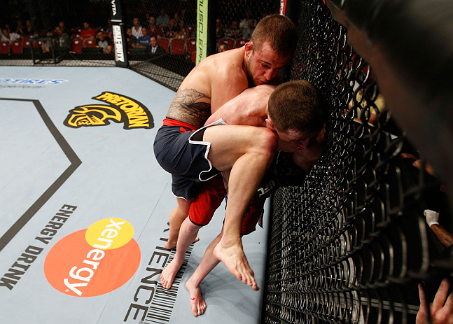 GOLD COAST, AUSTRALIA - DECEMBER 15:  (L-R) Mike Wilkinson knees Brendan Loughnane during their lightweight fight at the UFC on FX event on December 15, 2012  at Gold Coast Convention and Exhibition Centre in Gold Coast, Australia.  (Photo by Josh Hedges/