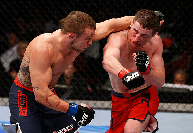 GOLD COAST, AUSTRALIA - DECEMBER 15:  (R-L) Brendan Loughnane and Mike Wilkinson trade punches during their lightweight fight at the UFC on FX event on December 15, 2012  at Gold Coast Convention and Exhibition Centre in Gold Coast, Australia.  (Photo by 