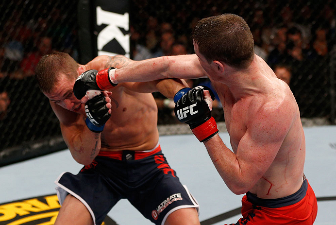 GOLD COAST, AUSTRALIA - DECEMBER 15:  (R-L) Brendan Loughnan punches Mike Wilkinson during their lightweight fight at the UFC on FX event on December 15, 2012  at Gold Coast Convention and Exhibition Centre in Gold Coast, Australia.  (Photo by Josh Hedges