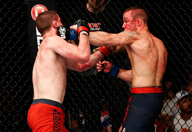 GOLD COAST, AUSTRALIA - DECEMBER 15:  (R-L) Mike Wilkinson punches Brendan Loughnane during their lightweight fight at the UFC on FX event on December 15, 2012  at Gold Coast Convention and Exhibition Centre in Gold Coast, Australia.  (Photo by Josh Hedge