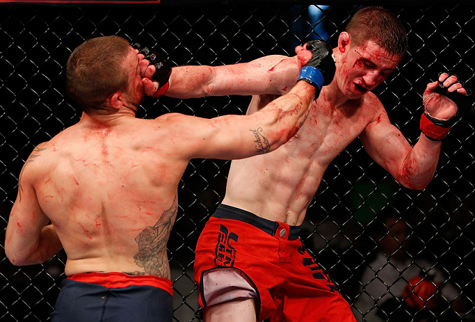 GOLD COAST, AUSTRALIA - DECEMBER 15:  (L-R) Mike Wilkinson punches Brendan Loughnane during their lightweight fight at the UFC on FX event on December 15, 2012  at Gold Coast Convention and Exhibition Centre in Gold Coast, Australia.  (Photo by Josh Hedge