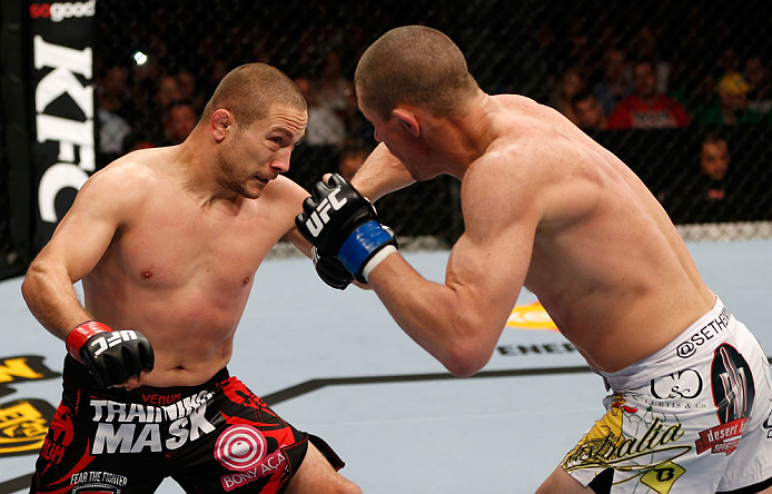 GOLD COAST, AUSTRALIA - DECEMBER 15:  (L-R) Mike Pierce and Seth Baczynski trade punches during their welterweight fight at the UFC on FX event on December 15, 2012  at Gold Coast Convention and Exhibition Centre in Gold Coast, Australia.  (Photo by Josh 