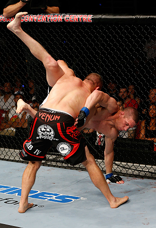 GOLD COAST, AUSTRALIA - DECEMBER 15:  (L-R) Mike Pierce takes down Seth Baczynski during their welterweight fight at the UFC on FX event on December 15, 2012  at Gold Coast Convention and Exhibition Centre in Gold Coast, Australia.  (Photo by Josh Hedges/