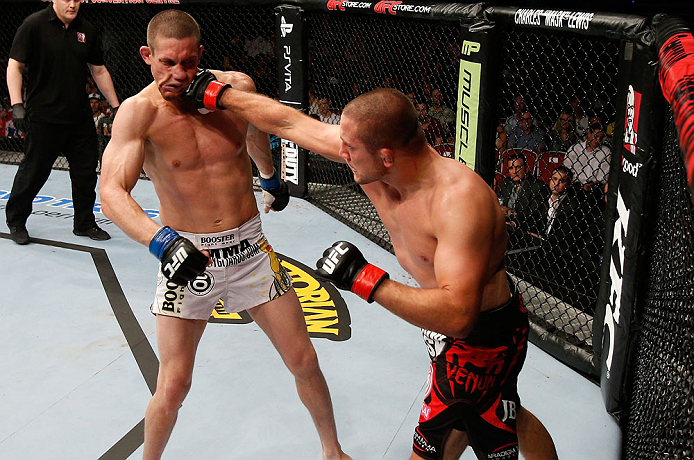 GOLD COAST, AUSTRALIA - DECEMBER 15:  (R-L) Mike Pierce punches Seth Baczynski during their welterweight fight at the UFC on FX event on December 15, 2012  at Gold Coast Convention and Exhibition Centre in Gold Coast, Australia.  (Photo by Josh Hedges/Zuf