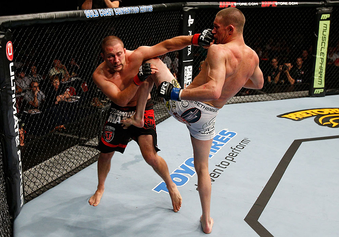 GOLD COAST, AUSTRALIA - DECEMBER 15:  (L-R) Mike Pierce and Seth Baczynski trade strikes during their welterweight fight at the UFC on FX event on December 15, 2012  at Gold Coast Convention and Exhibition Centre in Gold Coast, Australia.  (Photo by Josh 
