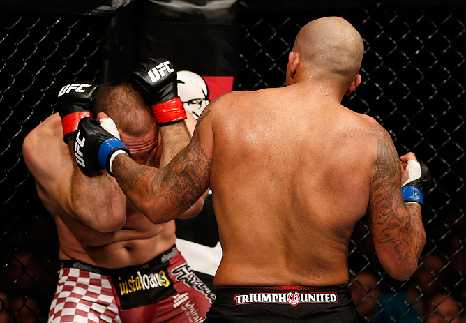 GOLD COAST, AUSTRALIA - DECEMBER 15:  (R-L) Joey Beltran punches Igor Pokrajac during their light heavyweight fight at the UFC on FX event on December 15, 2012  at Gold Coast Convention and Exhibition Centre in Gold Coast, Australia.  (Photo by Josh Hedge