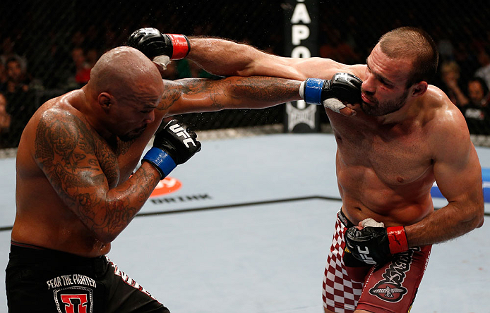 GOLD COAST, AUSTRALIA - DECEMBER 15:  (L-R) Joey Beltran punches Igor Pokrajac during their light heavyweight fight at the UFC on FX event on December 15, 2012  at Gold Coast Convention and Exhibition Centre in Gold Coast, Australia.  (Photo by Josh Hedge