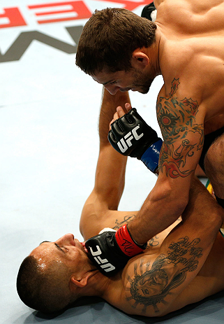 GOLD COAST, AUSTRALIA - DECEMBER 15:  (R-L) Chad Mendes knocks out Yaotzin Meza with punches during their featherweight fight at the UFC on FX event on December 15, 2012  at Gold Coast Convention and Exhibition Centre in Gold Coast, Australia.  (Photo by 