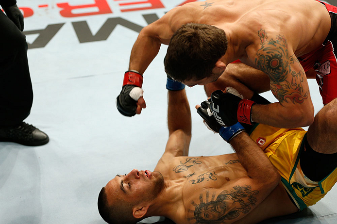 GOLD COAST, AUSTRALIA - DECEMBER 15:  (R-L) Chad Mendes knocks out Yaotzin Meza with punches during their featherweight fight at the UFC on FX event on December 15, 2012  at Gold Coast Convention and Exhibition Centre in Gold Coast, Australia.  (Photo by 