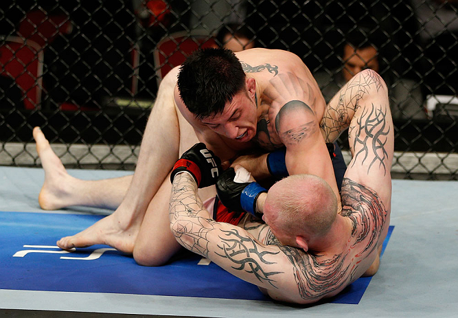 GOLD COAST, AUSTRALIA - DECEMBER 15:  (L-R) Norman Parke delivers an elbow strike against Colin Fletcher during their lightweight fight at the UFC on FX event on December 15, 2012  at Gold Coast Convention and Exhibition Centre in Gold Coast, Australia.  