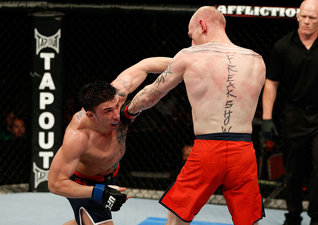 GOLD COAST, AUSTRALIA - DECEMBER 15:  (L-R) Norman Parke punches Colin Fletcher during their lightweight fight at the UFC on FX event on December 15, 2012  at Gold Coast Convention and Exhibition Centre in Gold Coast, Australia.  (Photo by Josh Hedges/Zuf