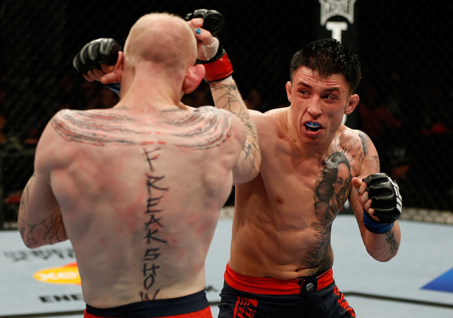 GOLD COAST, AUSTRALIA - DECEMBER 15:  (R-L) Norman Parke punches Colin Fletcher during their lightweight fight at the UFC on FX event on December 15, 2012  at Gold Coast Convention and Exhibition Centre in Gold Coast, Australia.  (Photo by Josh Hedges/Zuf