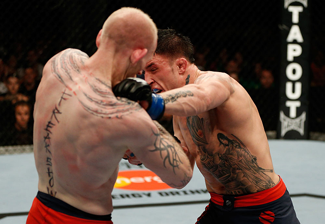 GOLD COAST, AUSTRALIA - DECEMBER 15:  (R-L) Norman Parke punches Colin Fletcher during their lightweight fight at the UFC on FX event on December 15, 2012  at Gold Coast Convention and Exhibition Centre in Gold Coast, Australia.  (Photo by Josh Hedges/Zuf