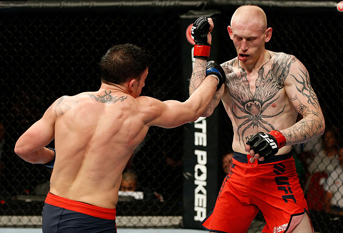 GOLD COAST, AUSTRALIA - DECEMBER 15:  (L-R) Norman Parke punches Colin Fletcher during their lightweight fight at the UFC on FX event on December 15, 2012  at Gold Coast Convention and Exhibition Centre in Gold Coast, Australia.  (Photo by Josh Hedges/Zuf